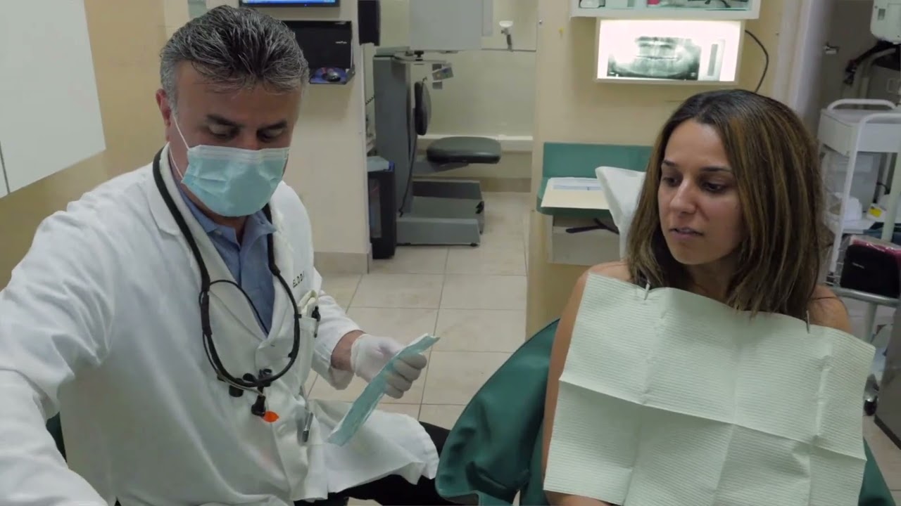 Dr. Korel working with a patient in the operatory